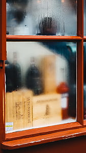 three wine bottles beside window thumbnail