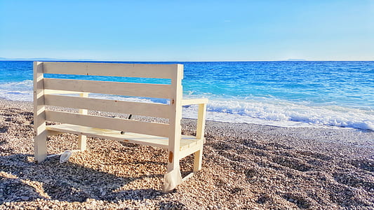 white wooden bench near beach thumbnail