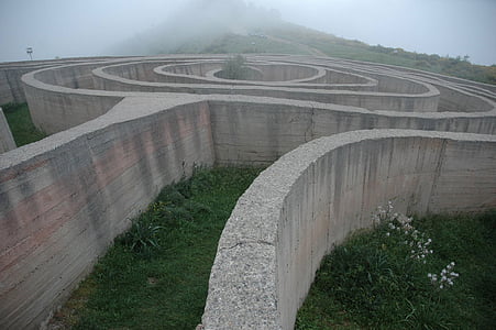 gray labyrinth with green grasses during daytime thumbnail