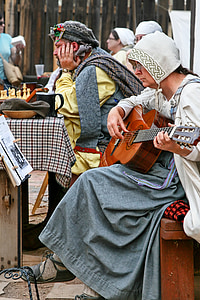 woman sitting on bench while playing guitar thumbnail