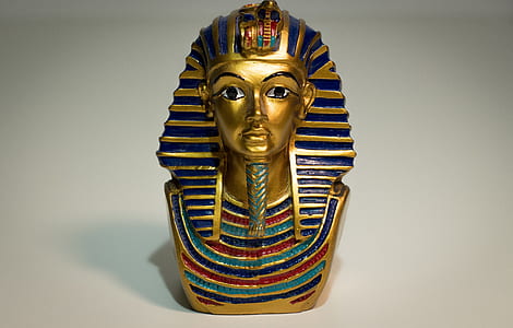 gold-colored and blue pharaoh figurine thumbnail