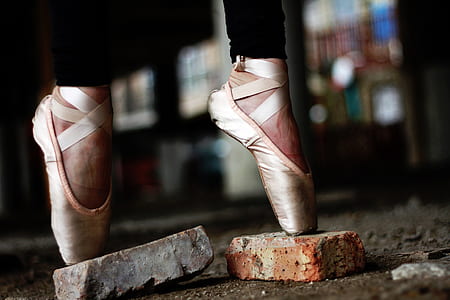 person in ballet shoes standing on bricks thumbnail