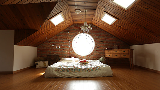 white bedspread on platform bed beside drawer in bed room thumbnail