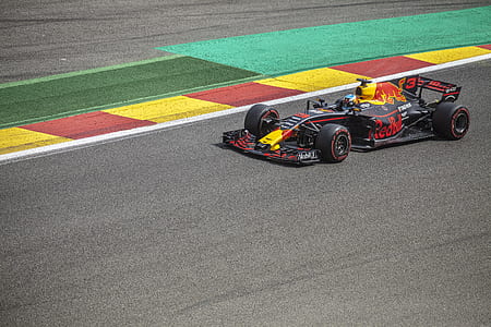 black and yellow F1 racer on road thumbnail
