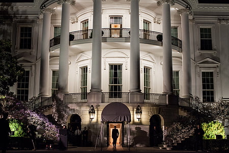 person walking inside white painted building thumbnail