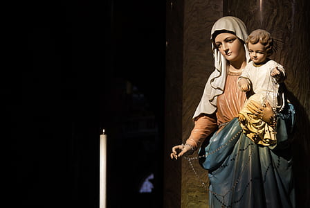 Madonna with child figurine near the lighted candle thumbnail