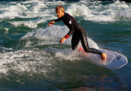 man surfing during daytime thumbnail