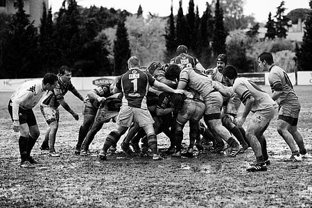 men playing rugby on open field thumbnail