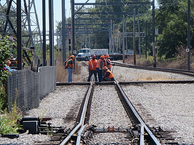 people working on train rails at daytime thumbnail