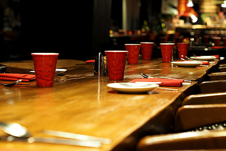 red disposable cups on dining table thumbnail