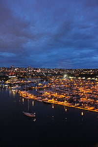 aerial photo of boat docks with lights under cloudy sky at night thumbnail