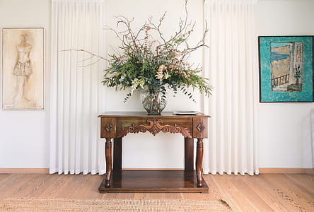 brown wooden console table with clear glass vase on top thumbnail