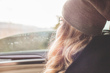Young & Beautiful Blonde Girl Looking Out of Car Window thumbnail