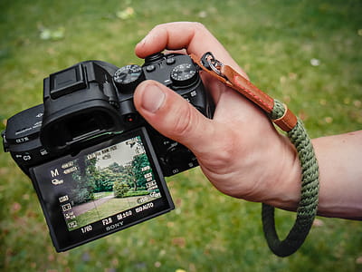 Close-Up Photo of Person Holding Black Camera thumbnail