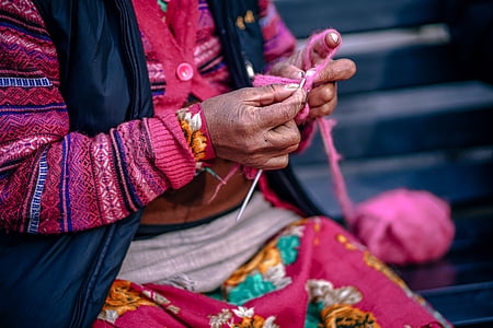person knitting with pink yarns thumbnail