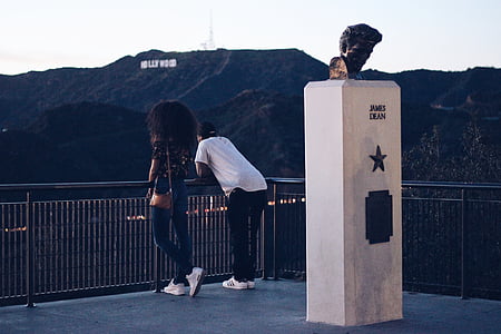 man and woman standing beside James Dean landmark thumbnail