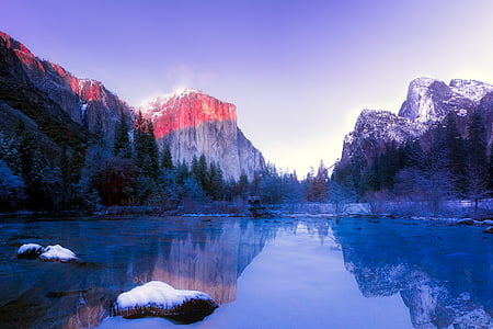 body of water near mountain at daytime thumbnail