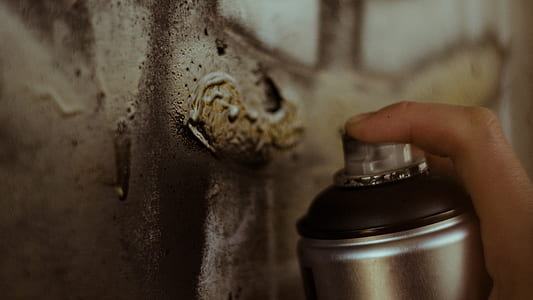 person spraying paint on wall thumbnail