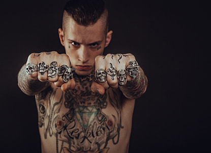 tattooed man making two fists thumbnail