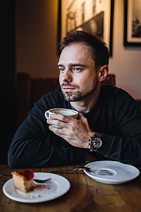 Young Elegantly dressed man sititng in a cafe thumbnail