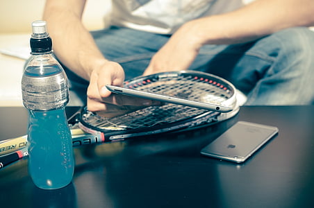 person holding iPad beside space gray iPhone 6 thumbnail