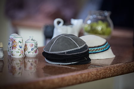 two gray and white caps on counter thumbnail