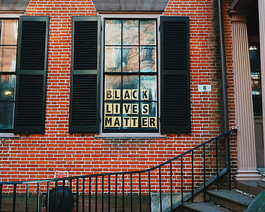 black wooden 2-door louver mirror during daytime thumbnail