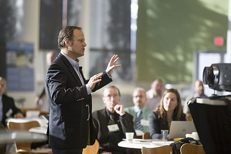 man wearing notched lapel suit jacket standing in front of camera thumbnail