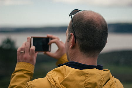 selective focus photography of man talking a photo thumbnail