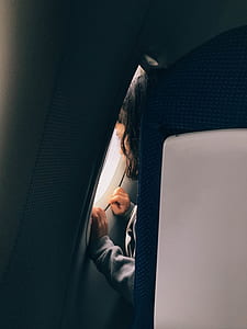 girl looking on airplane window thumbnail