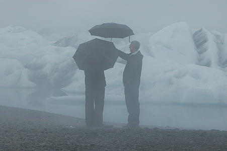 man in black jacket holding black umbrella thumbnail
