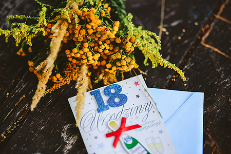Yellow flowers with miscellaneous items on wooden floor thumbnail