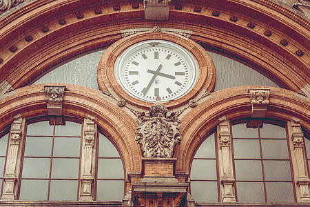low-angle photo of dome brown building with analog clock thumbnail