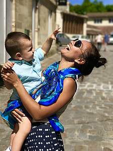 woman carrying a toddler thumbnail