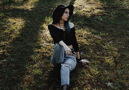 woman sitting on grass field thumbnail