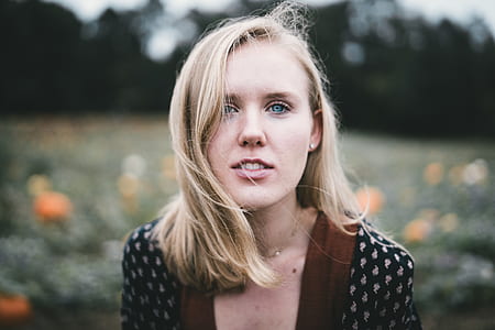 woman in brown and black top taking photo thumbnail
