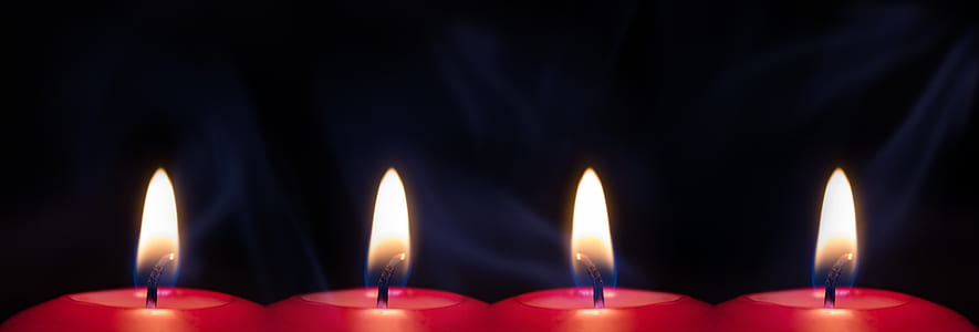 four red lit candles thumbnail