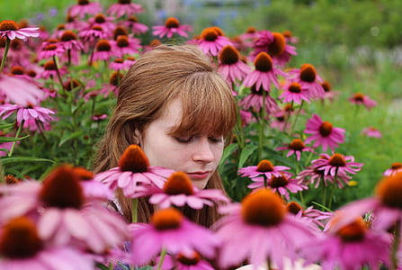 woman in coneflower field closing her eyes thumbnail