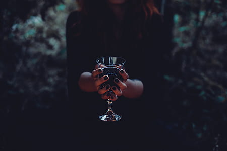 woman holding clear wing glass thumbnail