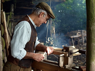 man carving wood at daytime thumbnail