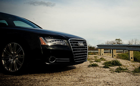 black car parked beside fence thumbnail