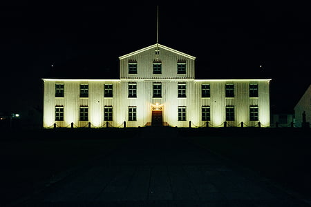white painted 3-storey building taken at nighttime thumbnail