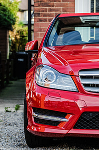 red Mercedes-Benz C-class near building thumbnail