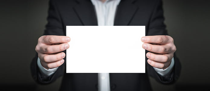 person holding white card thumbnail