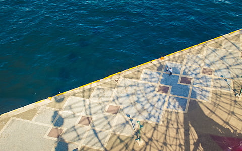 aerial photography of two persons standing near edge of platform thumbnail