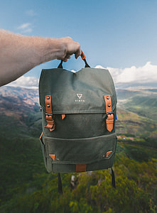 person holding gray knapsack thumbnail