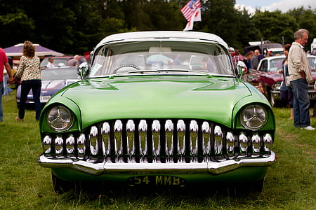 green and white car parked at green grass field during daytime thumbnail