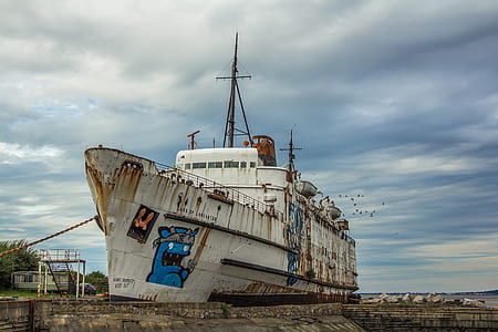 wrecked white boat on dock thumbnail