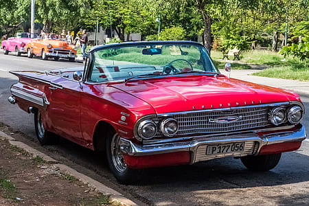 red convertible muscle coupe on road at daytime thumbnail
