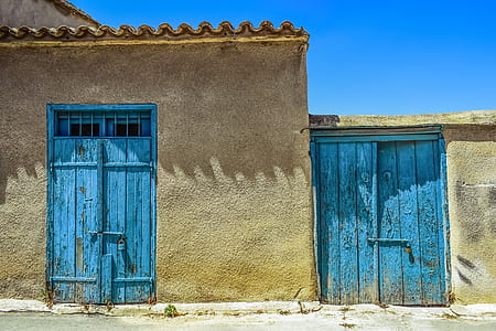 minimalist photography of two blue wooden doors thumbnail